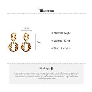 Detail view of leopard print acrylic geometric earrings with size specs of 8cm by 4cm