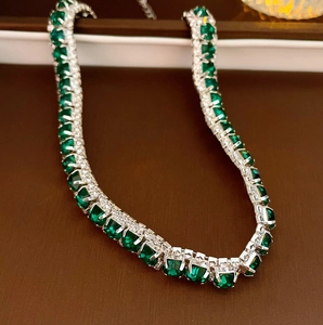 Macro detail of vintage emerald square necklace with silver-tone metal setting