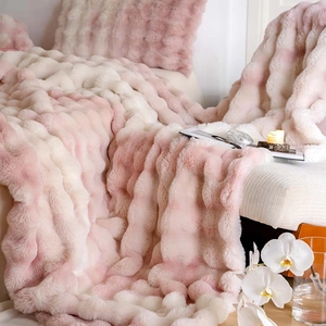 Macro detail of plush faux rabbit fur blanket featuring pink and white gradient stripes
