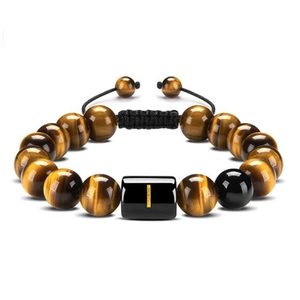 Macro detail of natural tiger eye beads and black woven cord on a handmade bracelet
