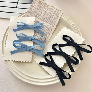 Set of 6 sweet ribbon bow hair clips in blue and black colors on a card display