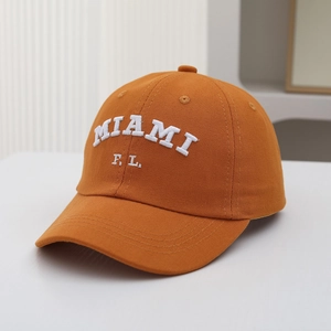 Detailed view of white MIAMI F.L. embroidery on premium orange cotton baseball cap