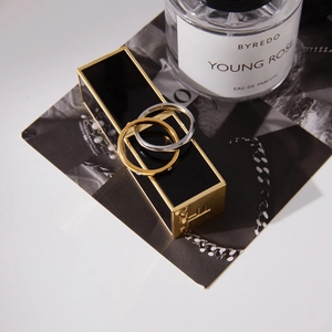 Polished 18K gold and silver stainless steel intertwined rings in a luxury setting