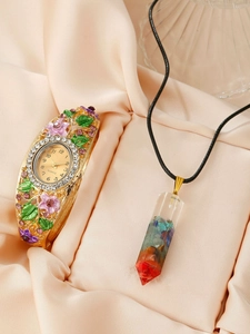 Floral cloisonne quartz watch and colorful resin crystal necklace set on pink fabric