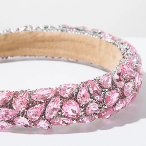 Close-up of pink crystal rhinestones in various cuts on a silver baroque headband