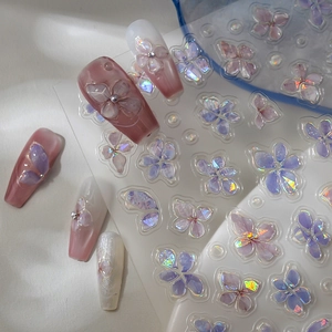 Close-up of 5D jelly embossed nail stickers with 3D floral designs and holographic finish