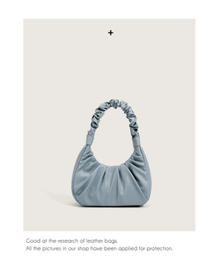 Close-up of light blue pleated cloud bag featuring premium PU leather and smooth texture
