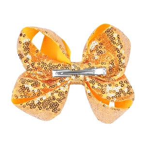 Detail of a 5 inch orange sequin bow hair clip with a silver metal duckbill clip