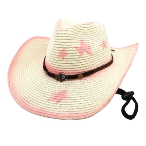 Detail of straw cowboy hat with pink stars, Hamsa charm, and braided band texture
