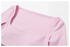 Detailed close-up of the square neckline on this pink long-sleeve athletic yoga top