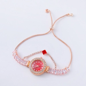 Detail of rose gold watch with red dial, rhinestones and adjustable slider closure