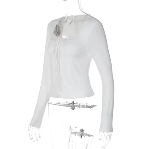 Detailed side view of slim fit white long sleeve top with lace trim and ribbon tie
