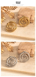Close-up of spiral crescent starfish stud earrings in gold and silver steel finish