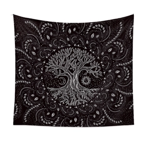 Detail of tree of life tapestry showing intricate sun moon motifs on black fabric