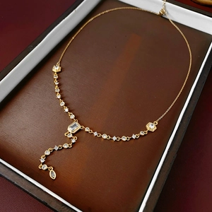 Detailed macro view of gold plated Y-necklace with emerald cut cubic zirconia pendant