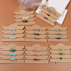 Macro view of multi-color natural crystal stone bracelets on brown kraft paper cards