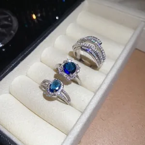 Sparkling blue zircon geometric ring set with oval and square stones in white gold finish