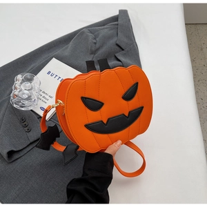Detail of Halloween pumpkin crossbody bag with black bat charm and zip closure