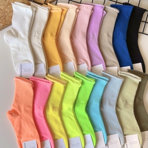 Colorful rolled-edge cotton socks in various vibrant colors with white paper tags