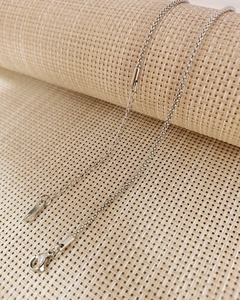 Detail of silver woven chain necklace showing the lobster clasp and extension link