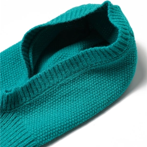 Detail of teal knit winter neck warmer and hat combo featuring soft ribbed texture