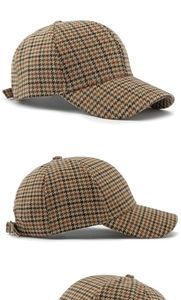 Detail view of houndstooth baseball cap with metal buckle and premium fabric texture