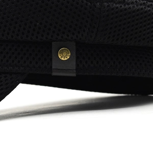 Close-up of black breathable mesh hat featuring metal button with U.S.A STYLE engraving