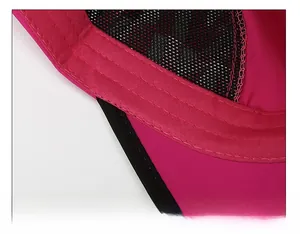 Detail of rose red sun hat featuring thick black sweatband and breathable mesh fabric