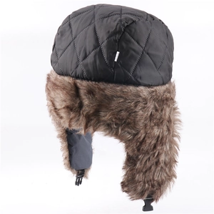 Detail of quilted windproof fabric and warm faux fur lining on winter trapper hat