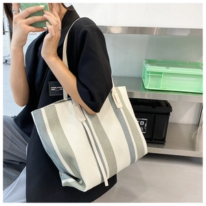 Detail of the vertical stripes and canvas texture on a large tote bag for women