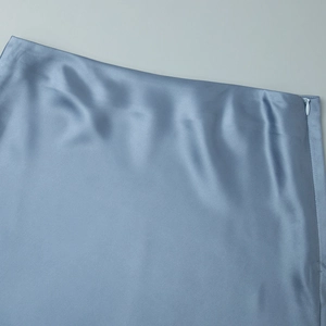 Detailed view of a light blue satin skirt showing a smooth invisible side zipper closure