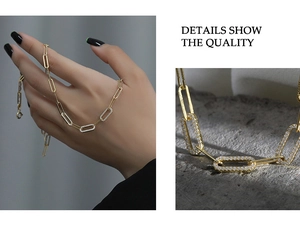 Macro detail of 925 silver gold-plated paperclip chain with micro-pave cubic zirconia links