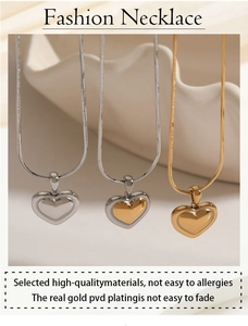 Close-up of heart pendant necklace displayed on wave stand in gold and silver