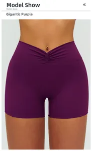 Detail view of high waist V-cut waistband on dark purple yoga shorts for fitness