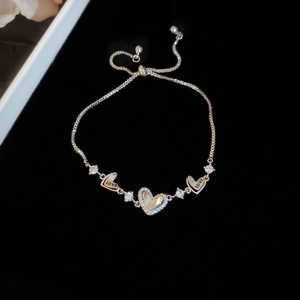 Close-up of adjustable silver heart bracelet with cubic zirconia and LOVE engraving