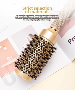 Detail of round hair brush with golden aluminum barrel and anti-slip champagne handle