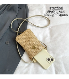 Mini straw woven crossbody phone bag with magnetic snap and smartphone inside