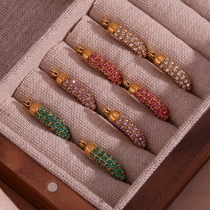 Detailed macro view of U-shaped gold-plated earrings with colorful pave zircon stones