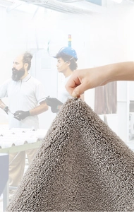 Detail of durable gray bathroom mat showing fiber strength and non-shedding texture