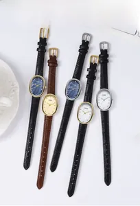 Detailed flat lay of five multicolor quartz watches with crocodile-patterned leather straps