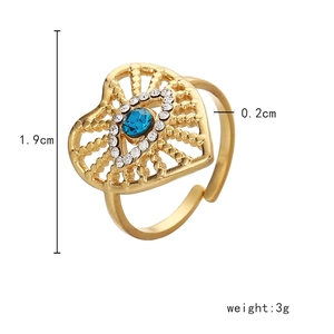 Detail showing 1.9cm gold hollow heart ring with blue gemstone and white crystals