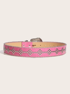 Detail view of pink crocodile pattern belt with punk style metal studs and heart buckle