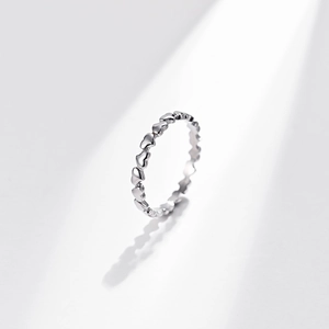 Minimalist silver stainless steel ring with linked heart design on white background