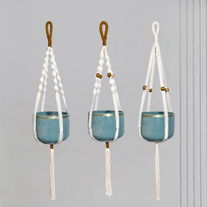 Three modern blue ceramic hanging planters with handmade cotton macrame rope and beads