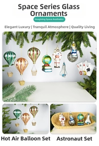 Detail of hand-painted glass astronaut and planet ornaments hanging on a Christmas tree