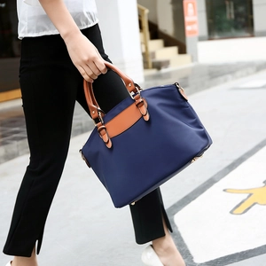 Navy blue Oxford fabric tote bag with brown leather trim and large capacity for women