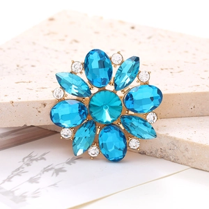 Macro shot of a floral alloy accessory with blue gemstones and white crystals