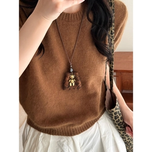 Winter plush bear pendant necklace with brown rope chain shown on a model