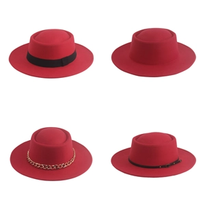 Detail view of four red wool felt fedora hats with various decorative bands and chains