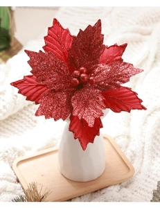 Detail of red velvet Christmas poinsettia flower with glitter petals and berry center